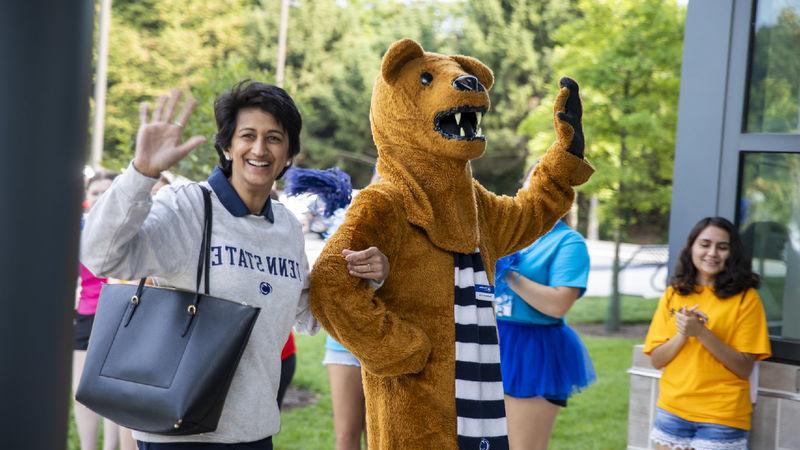 Nittany Lion mascot, left, waves to the crowd with Chancellor Pyati, right